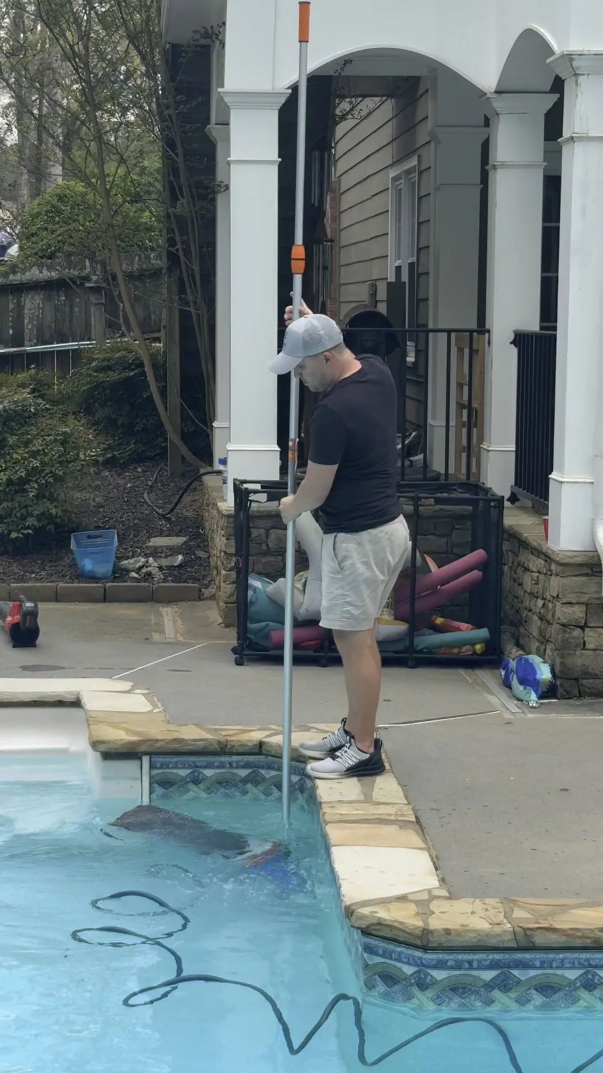 Corey skimming a pool on his daily route